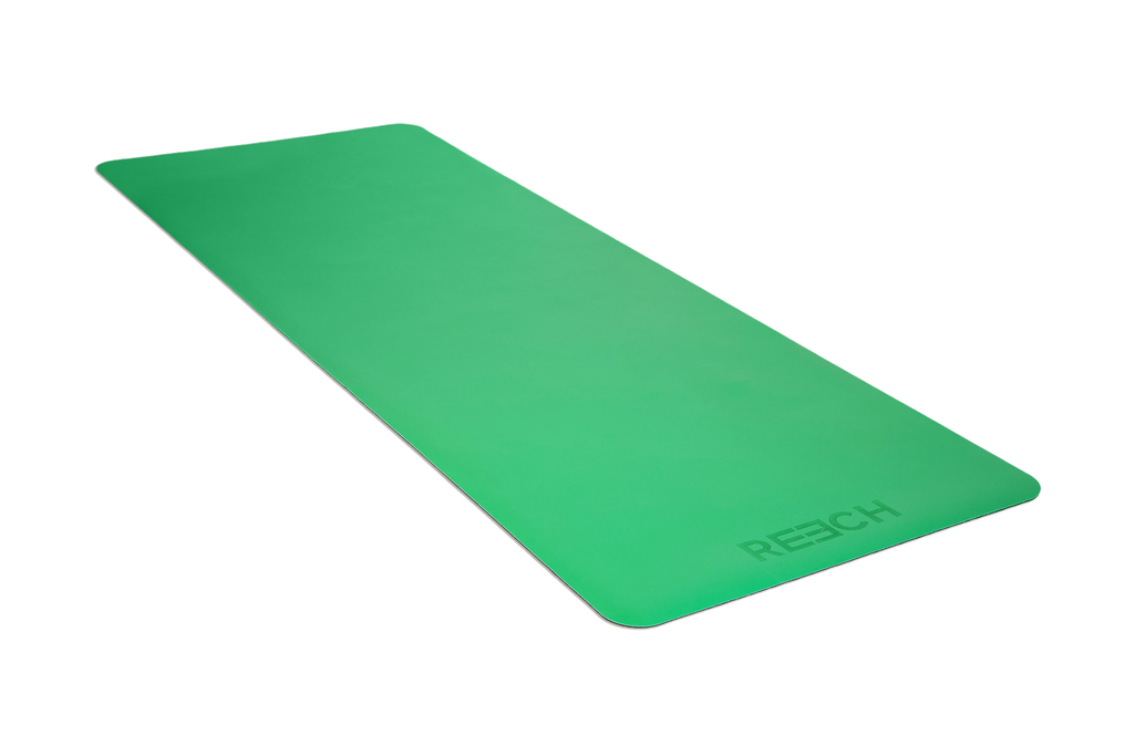 Flat green anti-bacterial & anti-microbial namaSTAY yoga mat on the ground.