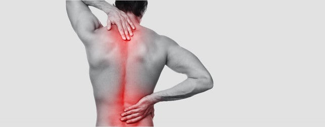 Back side of a shirtless man in black & white trying to rub spine (colored red to show pain).