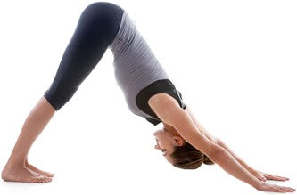 Woman in downward facing dog position.