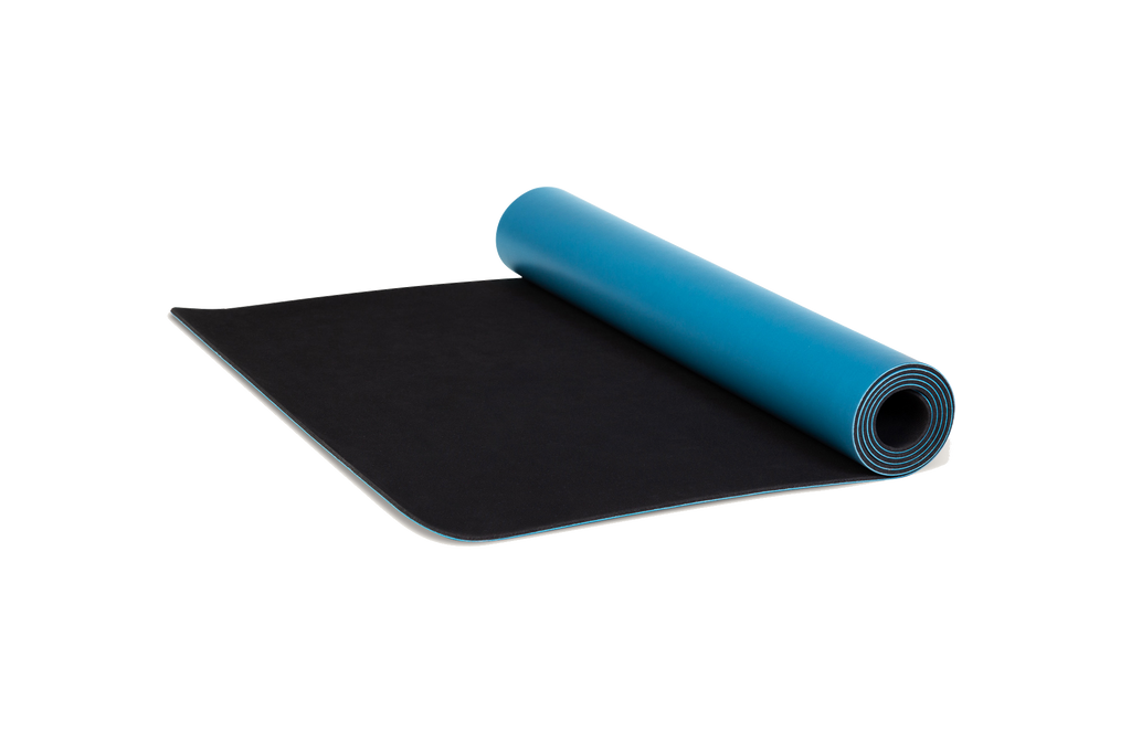 Eco-friendly blue yoga mat unrolling made from natural tree rubber.